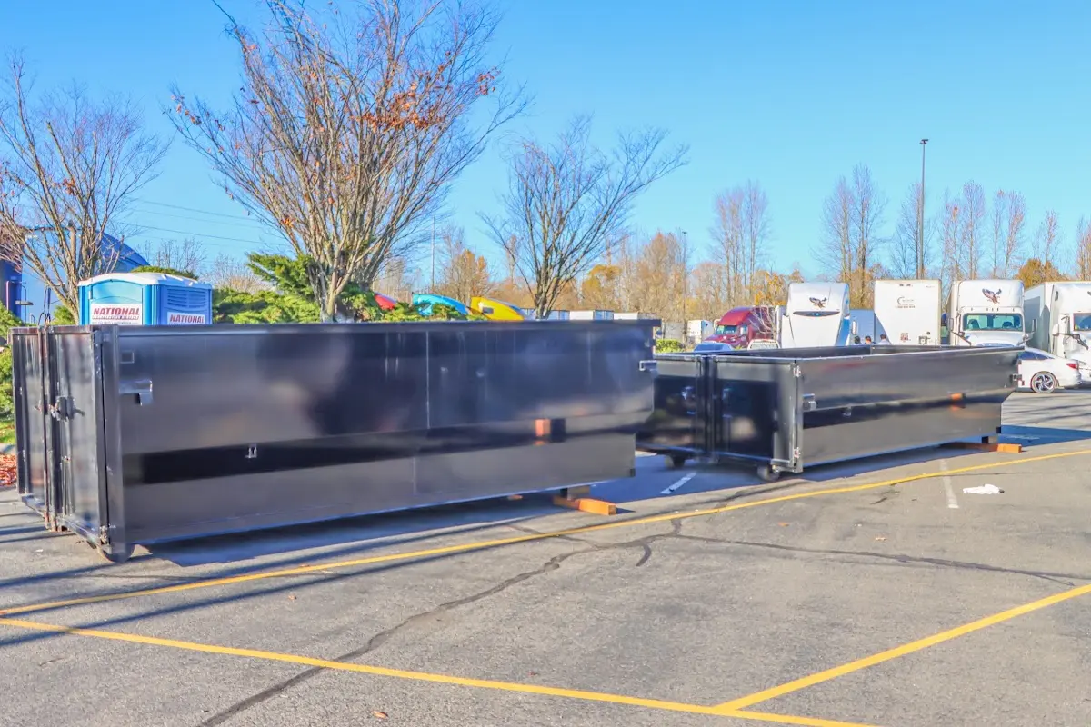 Professional dumpster rental service with roll-off container on residential driveway in St. Augustine